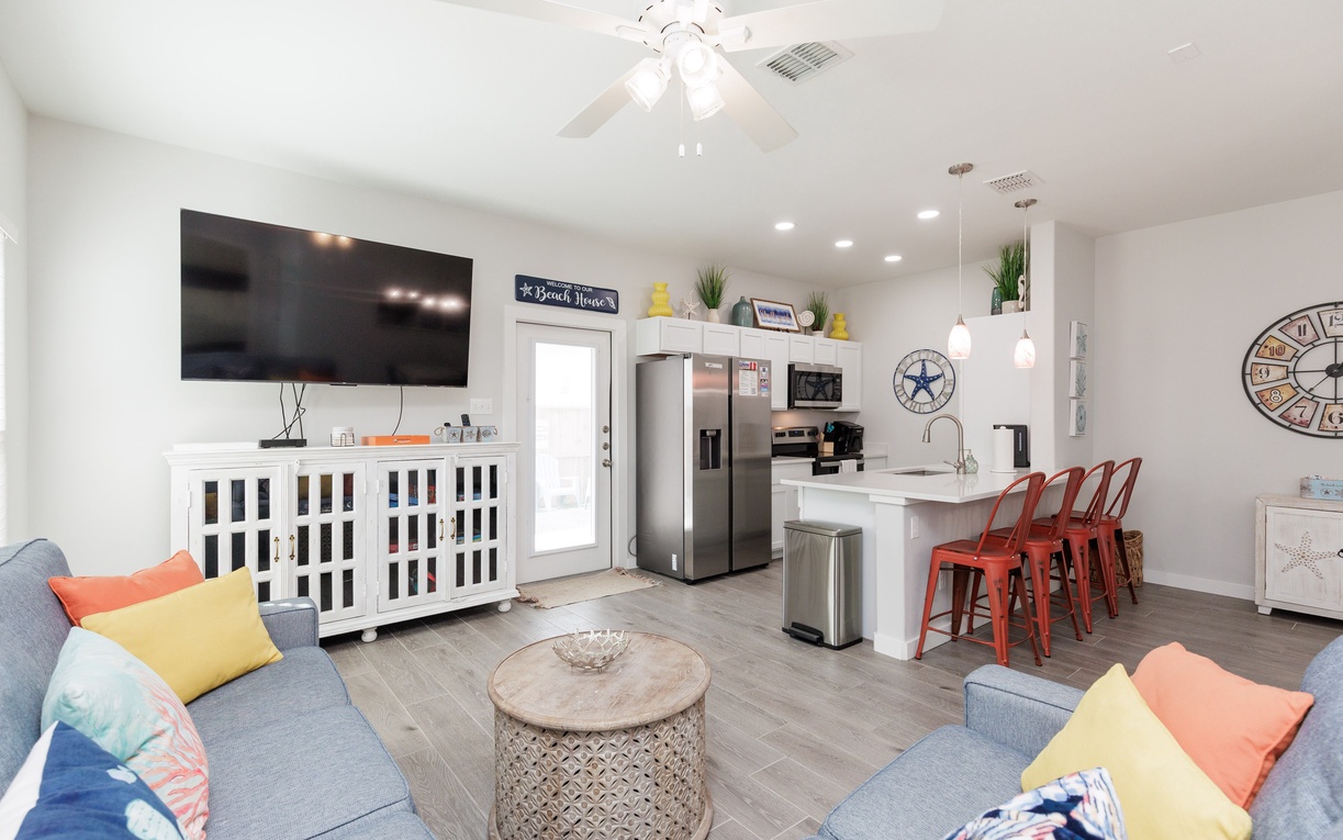 Unwind in your bright open-concept living space with coastal charm, modern kitchen, and cheerful accents that make you feel right at home.