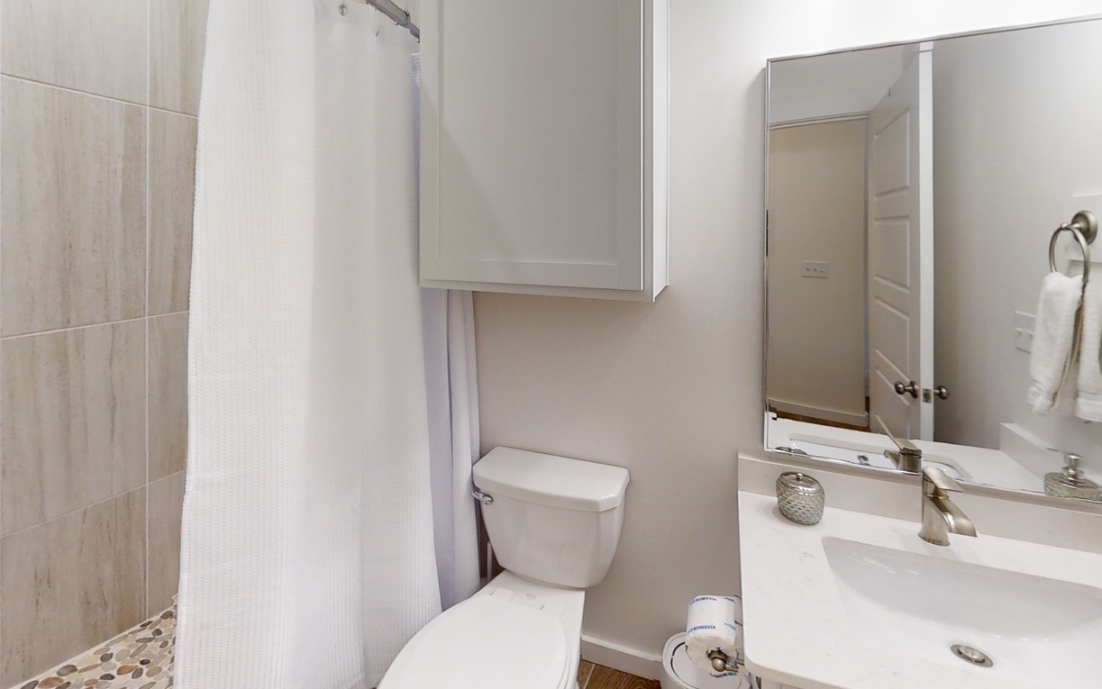 Refresh in your private bathroom featuring a spacious walk-in shower and modern amenities.