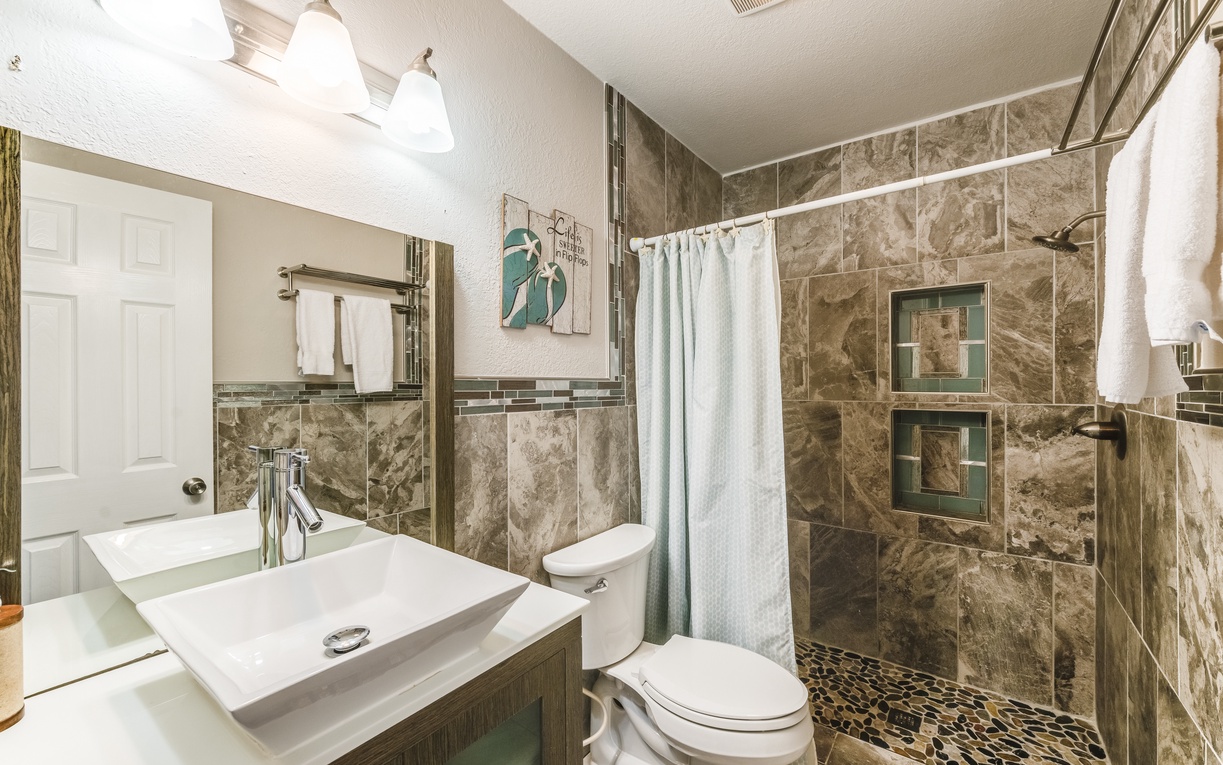 Luxurious marble bathroom with modern fixtures, spacious walk-in shower, and elegant towel amenities for your comfort.