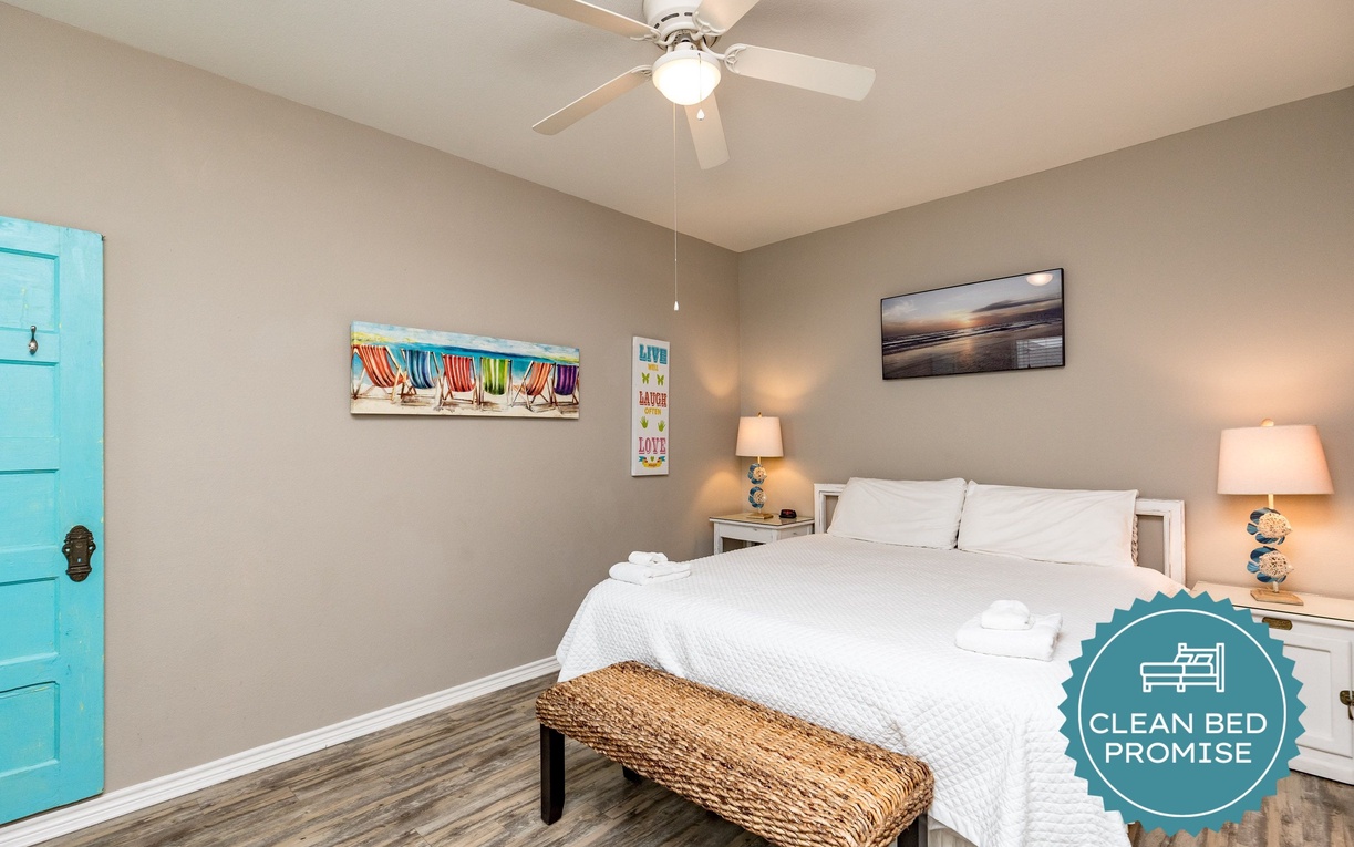 Sink into crisp white linens and let the ceiling fan's gentle breeze lull you to sleep in this cheerful coastal bedroom.