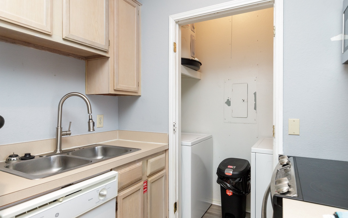 Your fully equipped kitchen flows seamlessly into a convenient laundry room, making meal prep and staying fresh effortless during your stay.