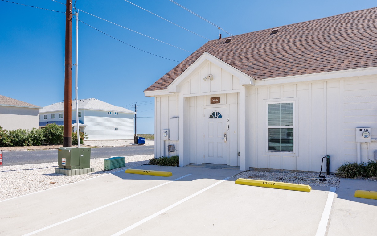 Charming coastal property with convenient parking and easy beach access in a quiet neighborhood setting.