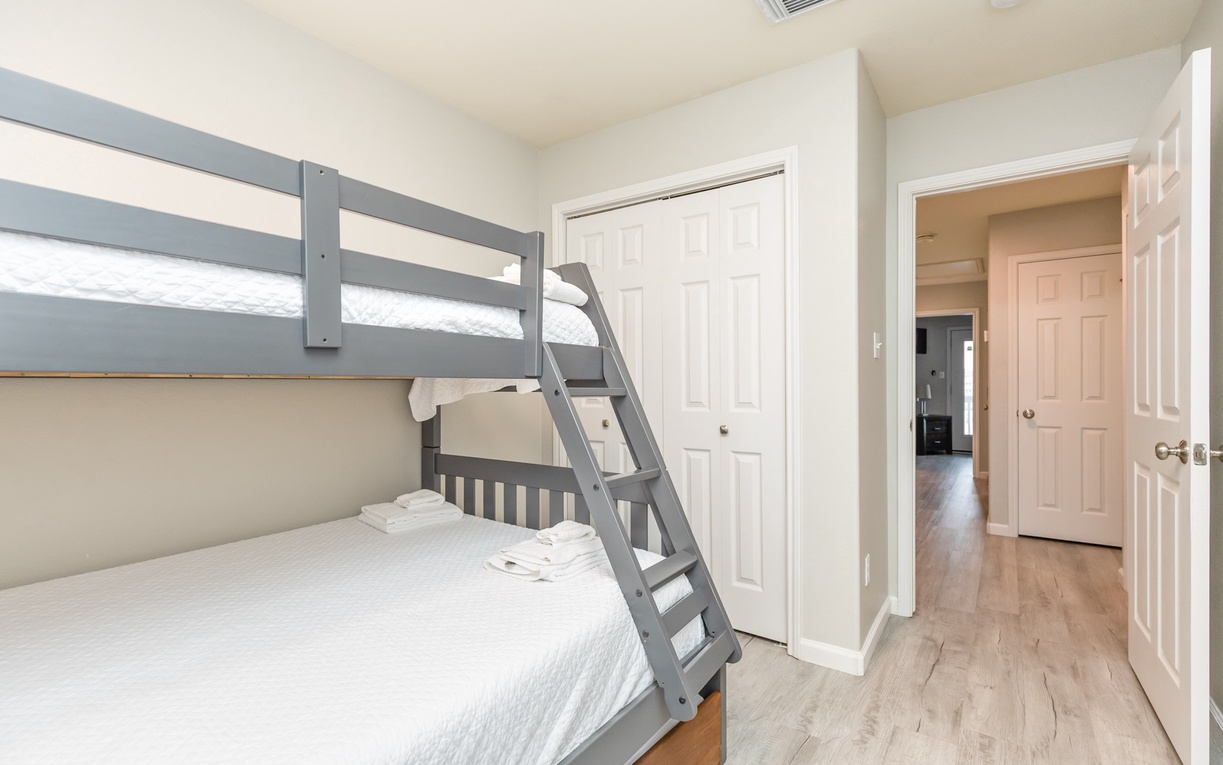 Rest comfortably in your thoughtfully designed bedroom featuring modern bunk beds with fresh linens and plenty of space to unwind.