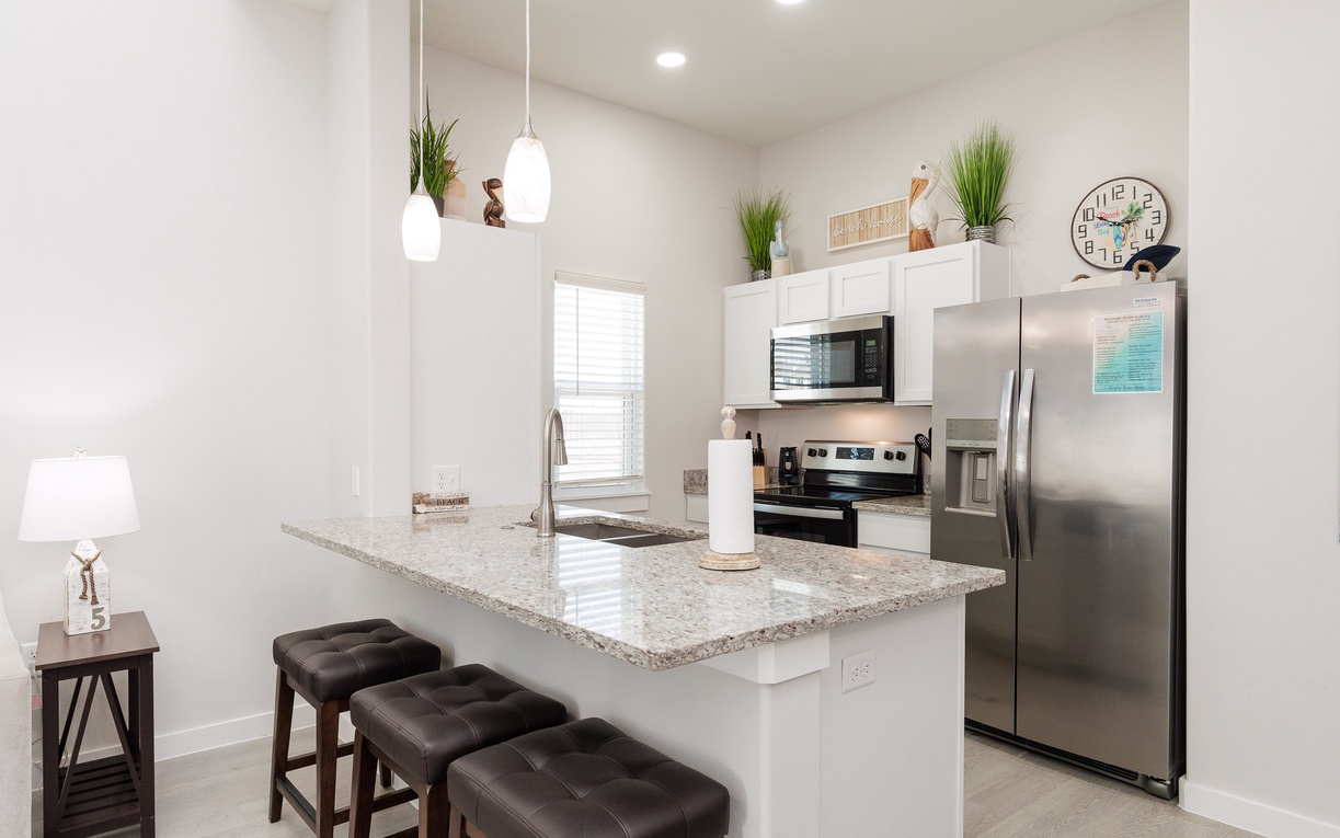 Your modern kitchen features granite countertops, stainless steel appliances, and stylish pendant lighting for memorable meal prep.