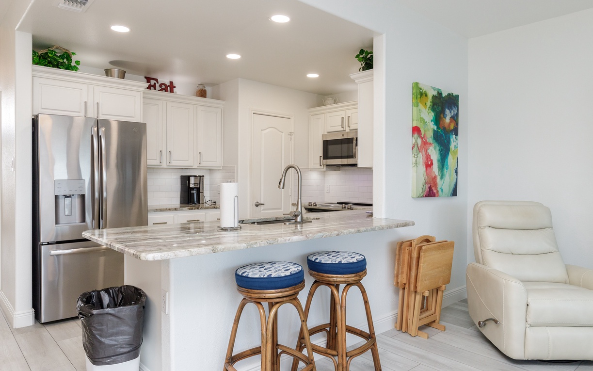 Your modern kitchen features granite countertops, stainless appliances, and a breakfast bar perfect for morning coffee or casual meals together.