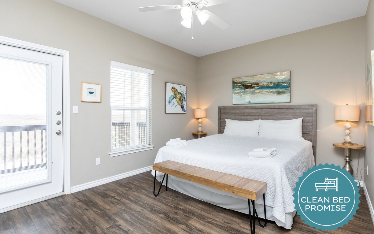 Drift off in your peaceful bedroom featuring plush bedding and calming coastal artwork, with a private balcony for your morning coffee.