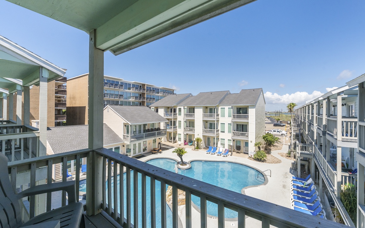 Step onto your private balcony and soak in the perfect pool view below, where sunny days invite you to unwind.