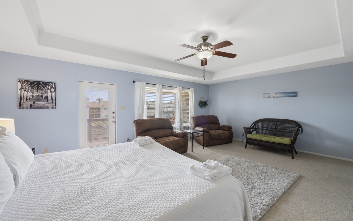 Relax in your spacious suite with a plush king bed, cozy seating area, and private balcony access. Soft coastal tones and thoughtful furnishings create your peaceful retreat after exploring.