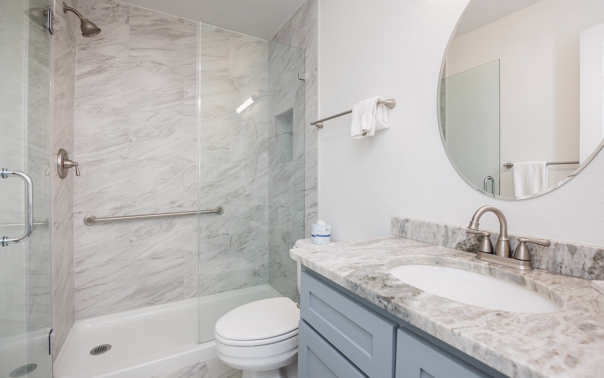 Your pristine marble bathroom awaits with a luxurious walk-in shower and elegant vanity for refreshing mornings.