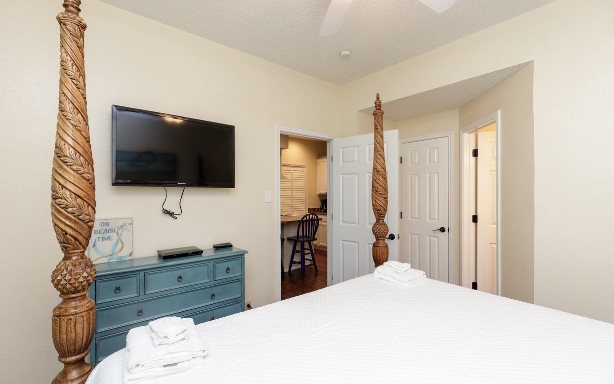 Rest peacefully in your charming bedroom with carved pineapple bed posts and coastal-inspired blue dresser, complete with flat-screen TV for relaxation.