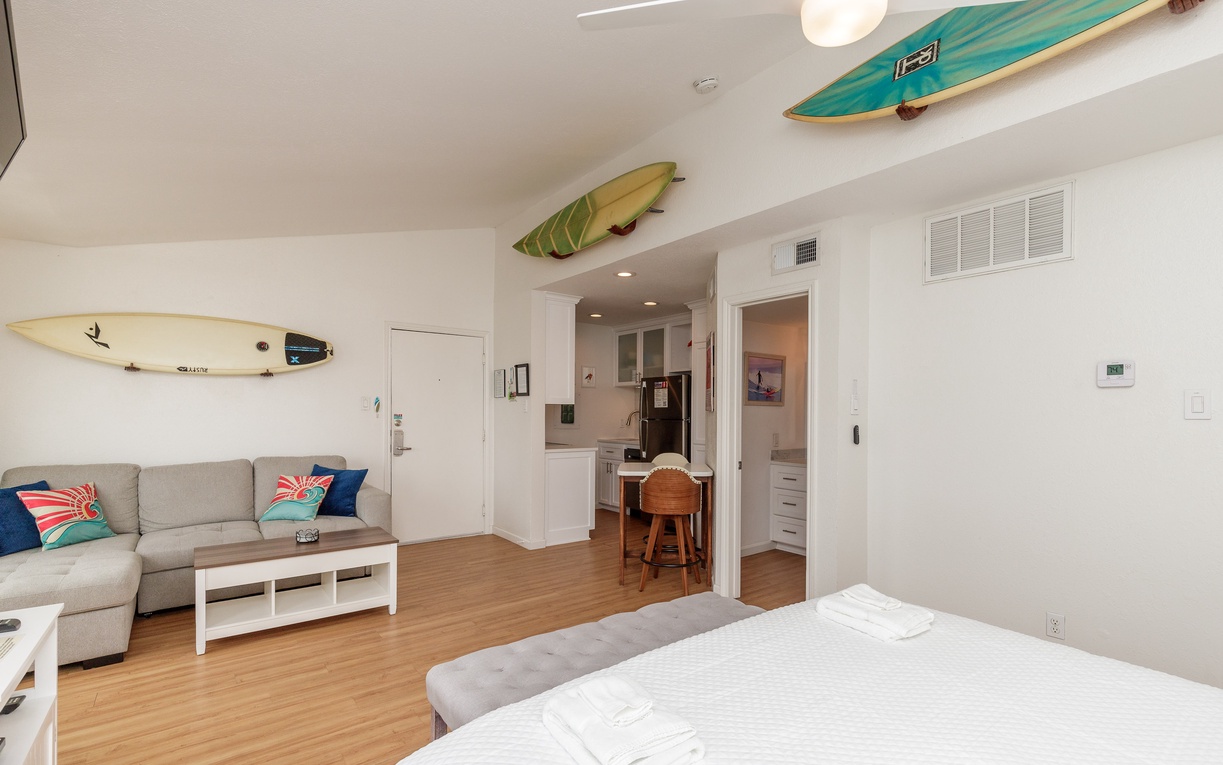 Your surf-inspired studio welcomes you with ocean vibes - surfboards overhead, cozy seating, and a bright kitchenette for beachside meals.