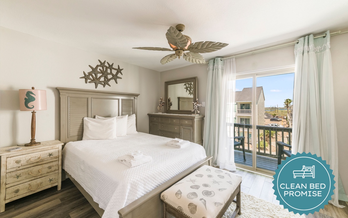 Wake up refreshed in your coastal-themed bedroom with crisp white linens and ocean views through the private balcony doors.