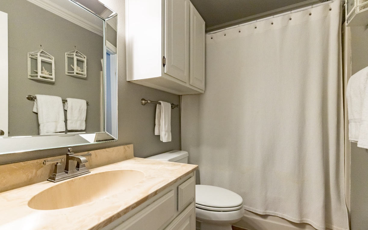 Your elegant bathroom features marble countertops, crisp white cabinetry, and plush towels for ultimate comfort.