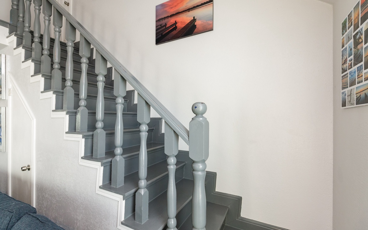This elegant stairway leads you to your comfortable retreat, with coastal artwork creating a welcoming first impression.