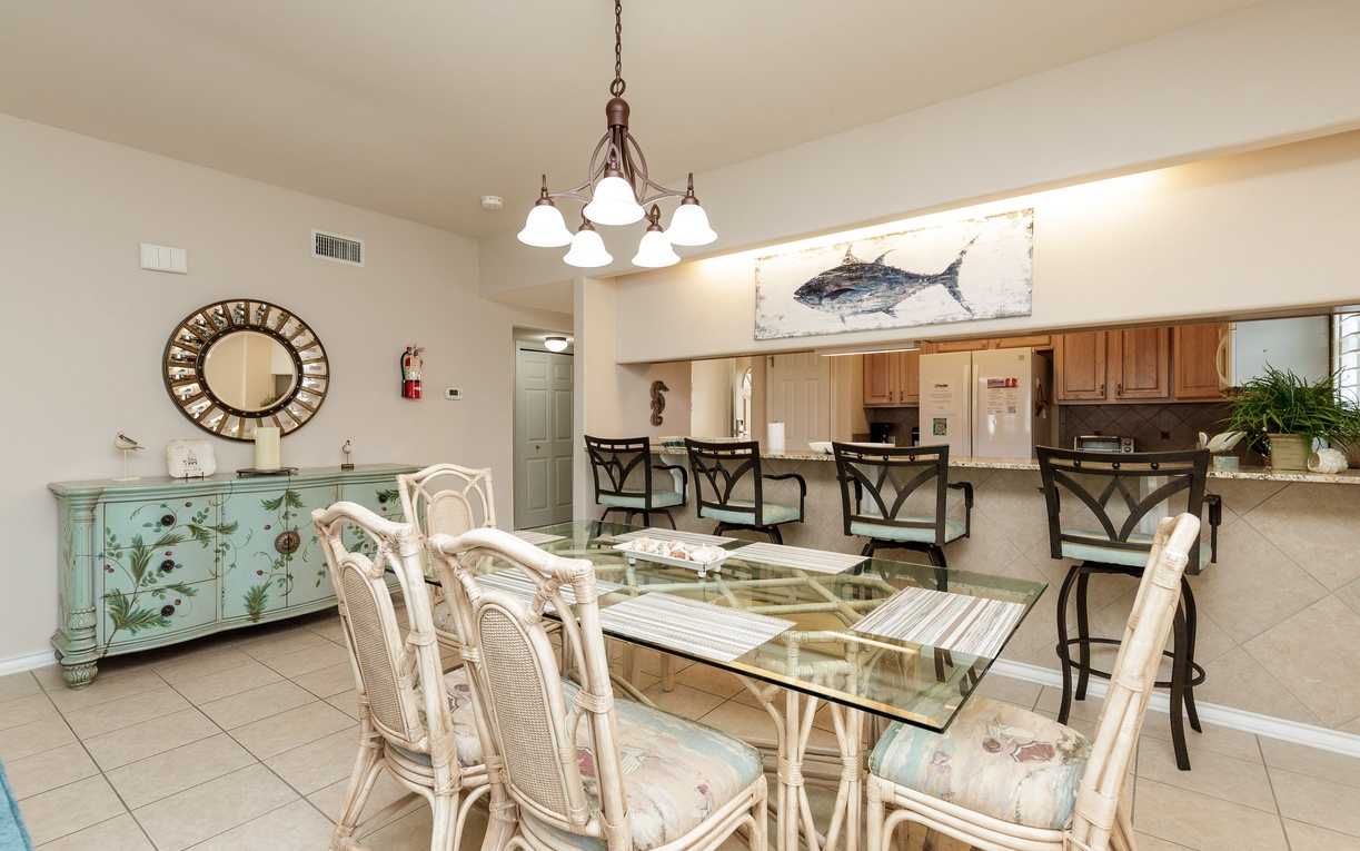 Gather around your elegant glass dining table where coastal charm meets comfort, perfect for memorable meals with family and friends.