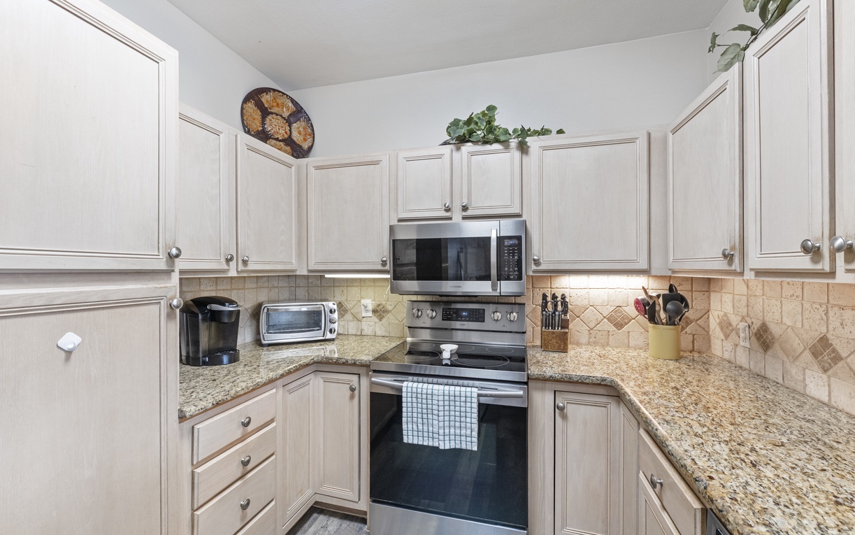 Your fully equipped kitchen awaits with granite counters, stainless appliances, and all the comforts of home for memorable meals.