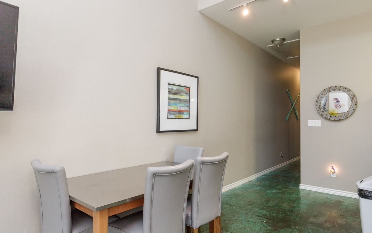 Gather around your stylish dining table for memorable meals in this thoughtfully designed space with modern artwork and polished concrete floors.