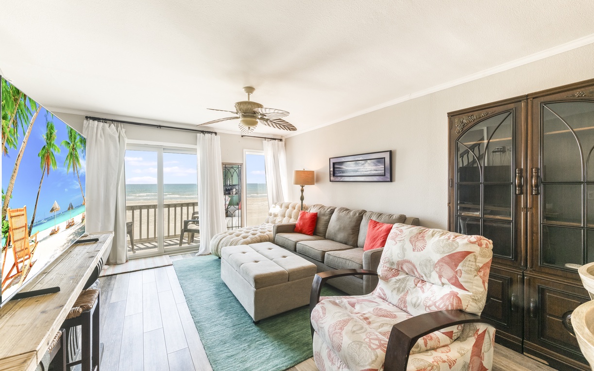 Sink into plush seating while ocean breezes flow through your private balcony doors, creating the perfect coastal retreat.