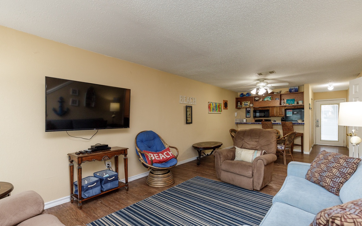 Unwind in your spacious living room with comfy seating, large TV, and coastal décor that sets the perfect beach vacation mood.