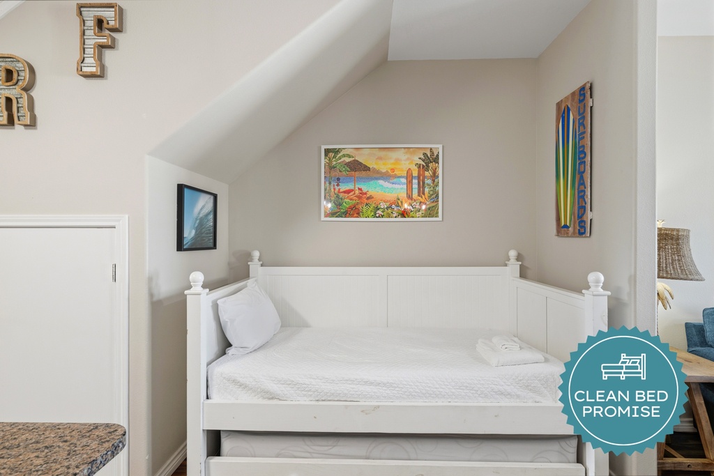 Slip into this bright, airy bedroom where coastal charm meets comfort. The crisp white linens and beachy accents create a peaceful retreat for your getaway.