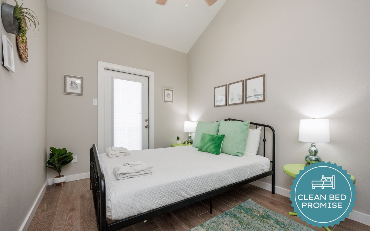 Relax in your bright bedroom featuring fresh linens, natural light, and calming green accents that create your perfect retreat.