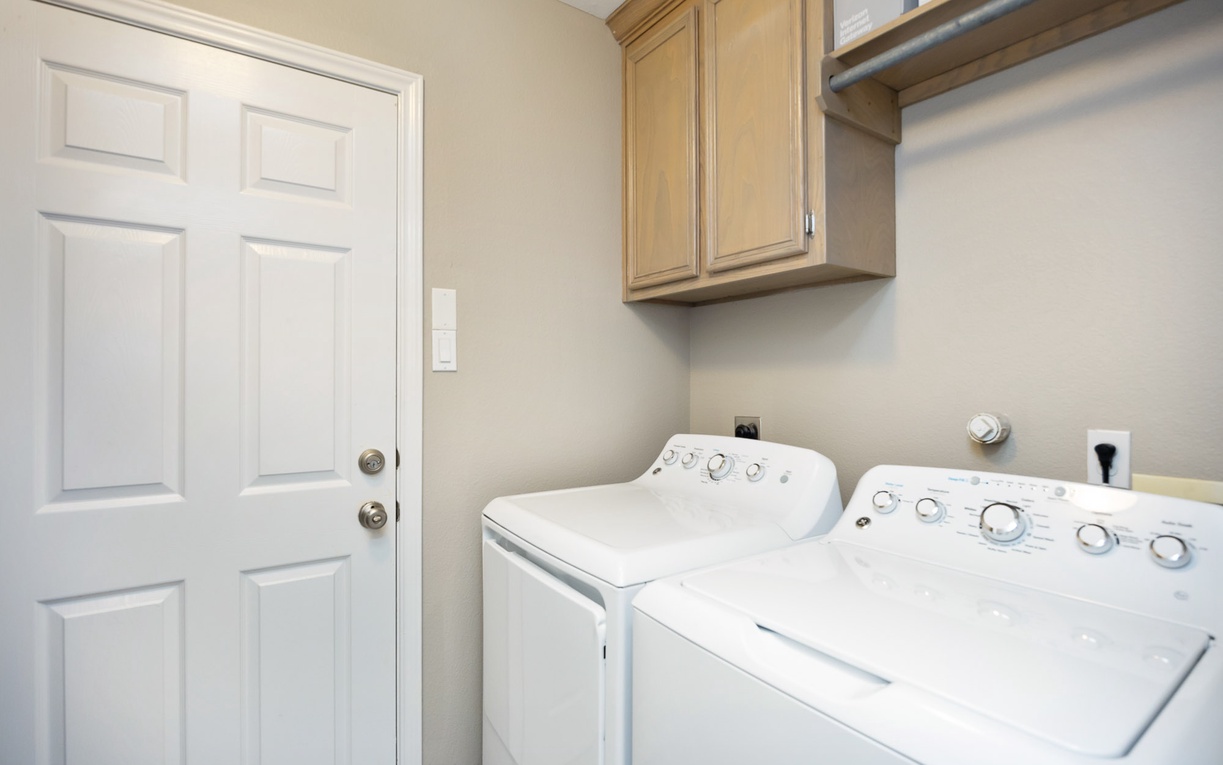 Your dedicated laundry room features full-size washer and dryer with upper storage, making extended stays effortless.
