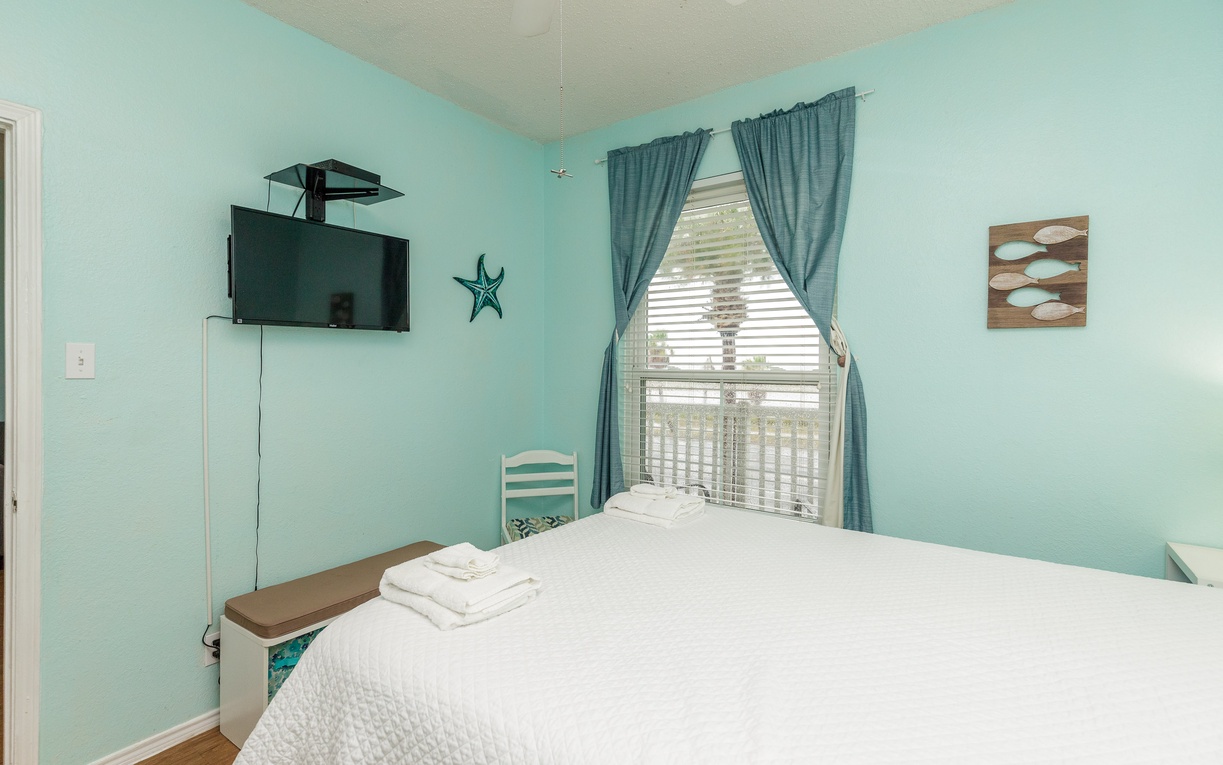 Drift off in this serene seafoam bedroom where soft aqua walls and ocean-themed decor create your peaceful coastal retreat.