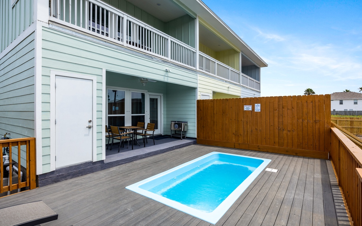 Your private oasis awaits with a sparkling plunge pool surrounded by warm wooden decking and comfortable patio seating.