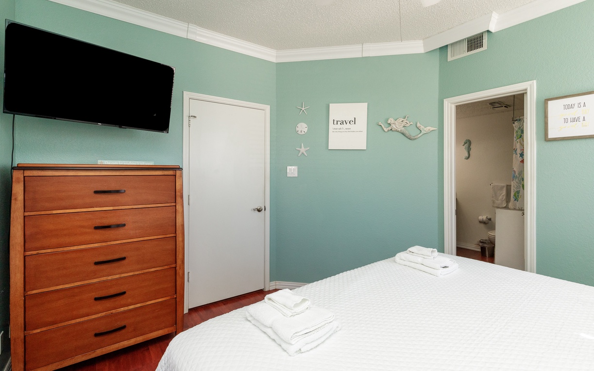 Unwind in your coastal-themed bedroom with soothing mint walls, crisp linens, and beach-inspired decor creating your perfect seaside retreat.