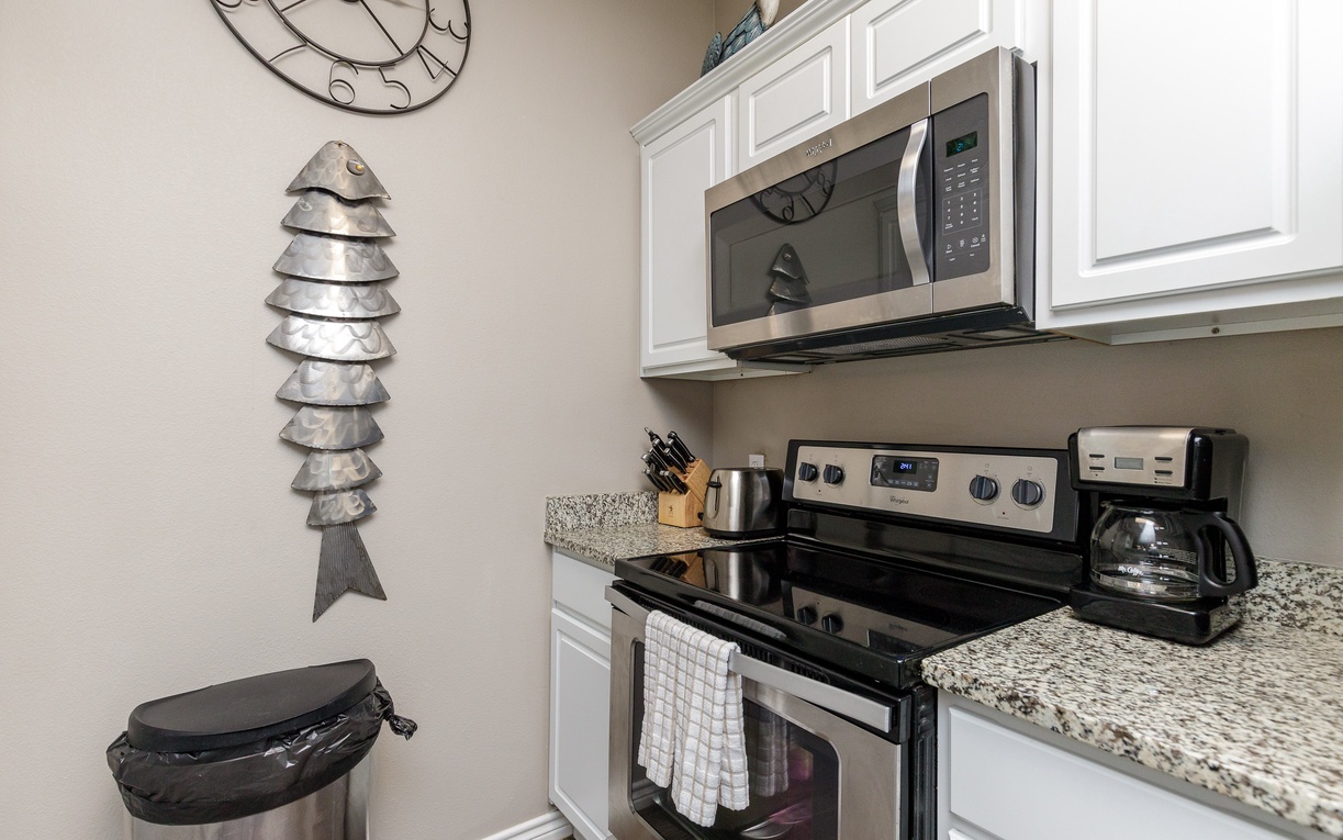 Your fully equipped kitchen features granite countertops, stainless steel appliances, and charming coastal decor to inspire your culinary adventures.