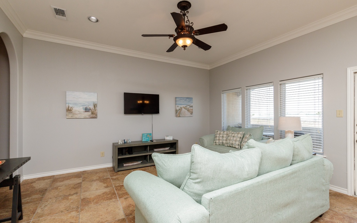 Sink into plush seating while enjoying your favorite shows on the wall-mounted TV in this bright, airy living space.