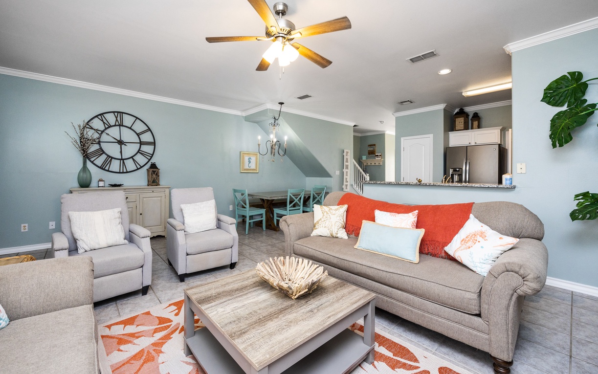 Unwind in your spacious living room featuring comfortable seating, coastal-inspired decor, and an open layout perfect for gathering with loved ones.