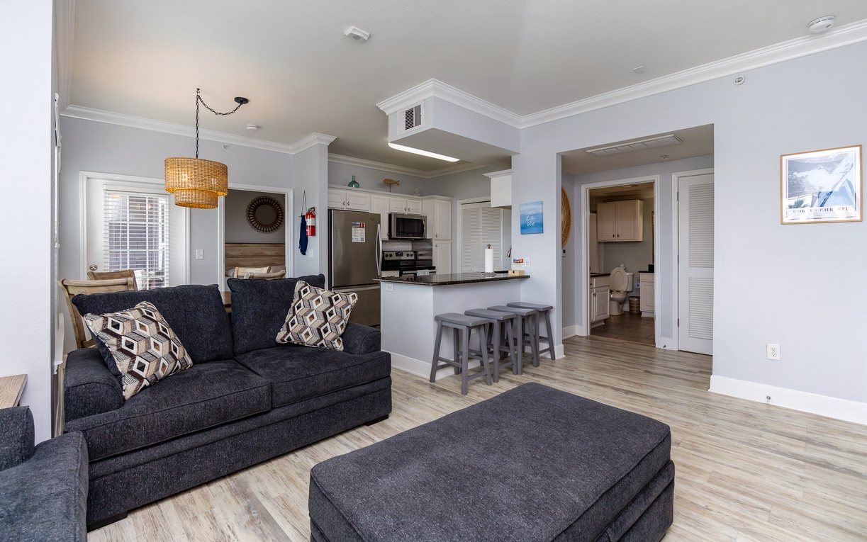 Relax in this bright, open-plan living space where your fully equipped kitchen flows seamlessly into comfortable seating areas.