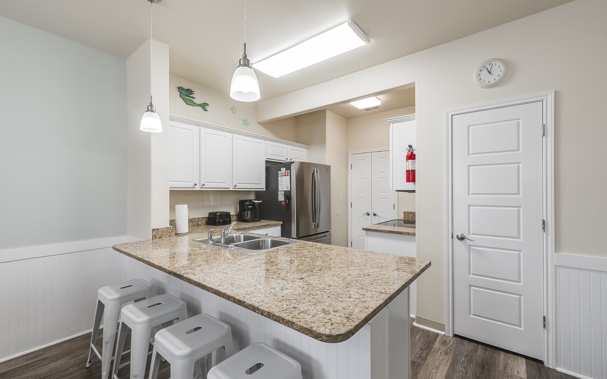 Your modern kitchen awaits with granite counters, stainless appliances, and bright skylights creating the perfect space for morning coffee or evening meals.