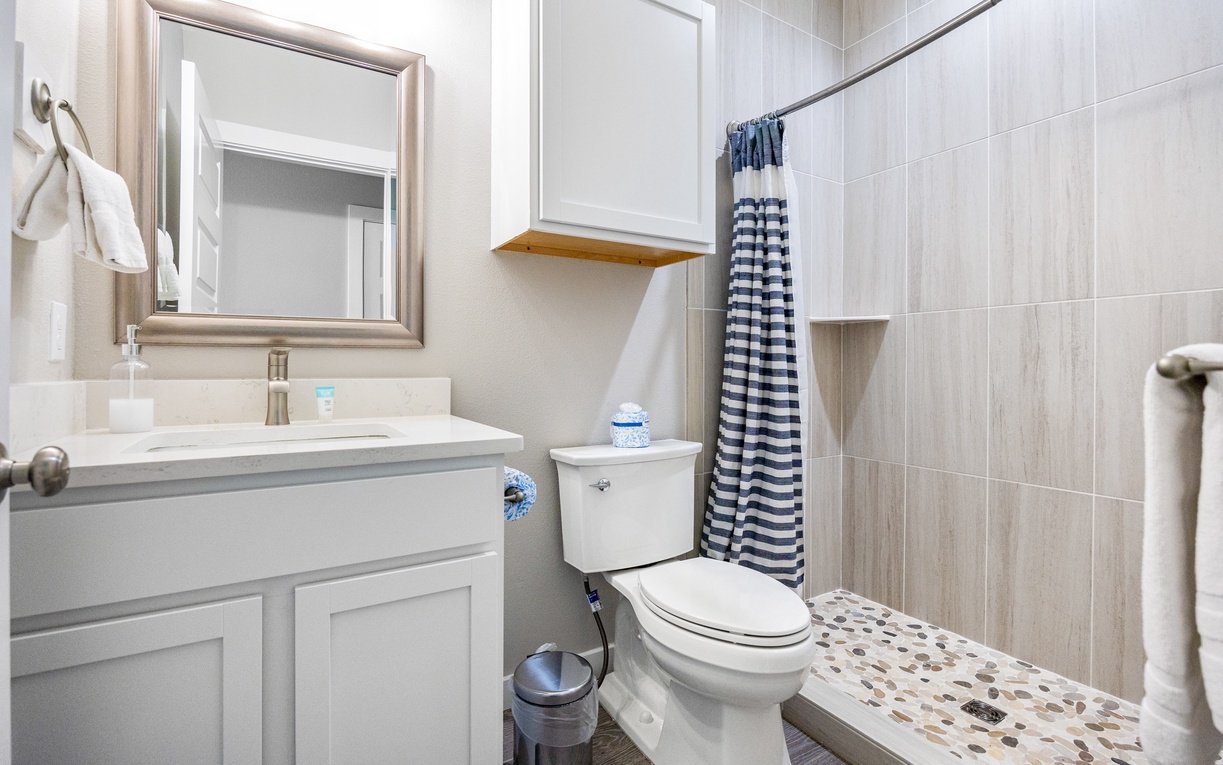 Your private bathroom features modern fixtures and a refreshing shower with coastal-inspired details to help you unwind.