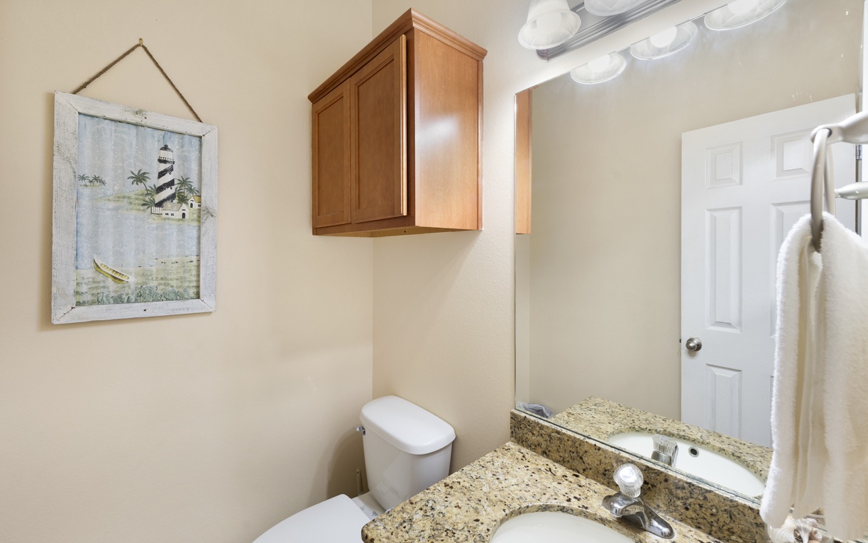 Freshen up in your bright, clean bathroom with granite countertops, coastal charm, and all the essentials you need for a comfortable stay.