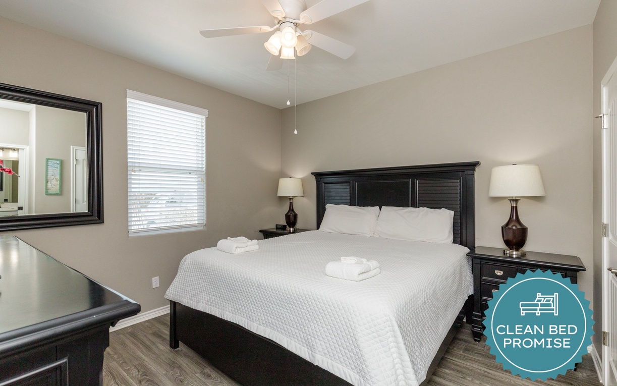 Your cozy bedroom features crisp white linens and a peaceful ceiling fan to keep you comfortable all night long.