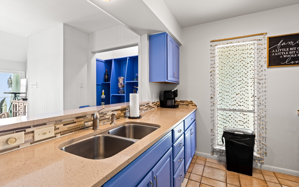 Your modern kitchen features bright blue cabinets, granite countertops, and all the essentials for preparing memorable meals during your stay.