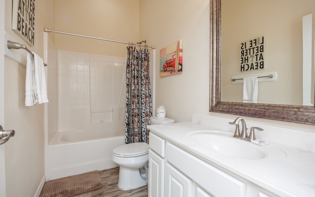 Refresh in your private bathroom with beach-themed touches and a relaxing tub/shower combo for unwinding after your adventures.