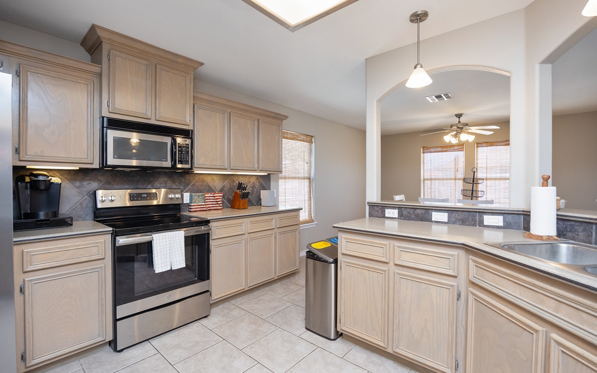 Your spacious kitchen features granite countertops, stainless steel appliances, and ample cabinet storage for all your culinary adventures.