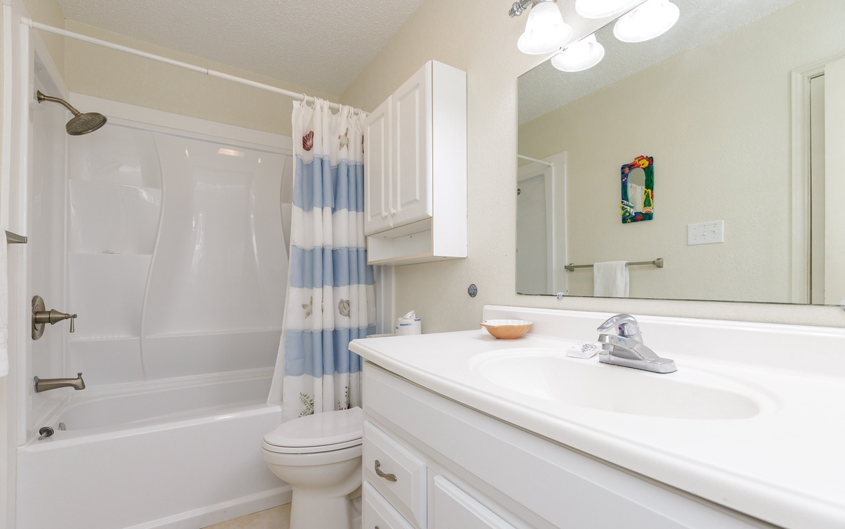 Refresh in your bright, clean bathroom featuring a full tub-shower combo and spacious vanity for your morning routine.