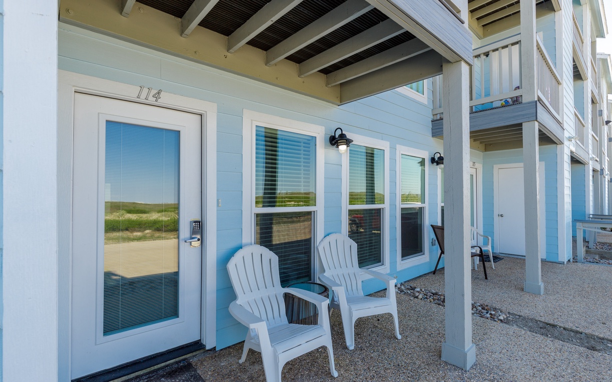 Relax in your private covered patio with comfortable Adirondack chairs, perfect for morning coffee or evening conversations while enjoying the peaceful surroundings.