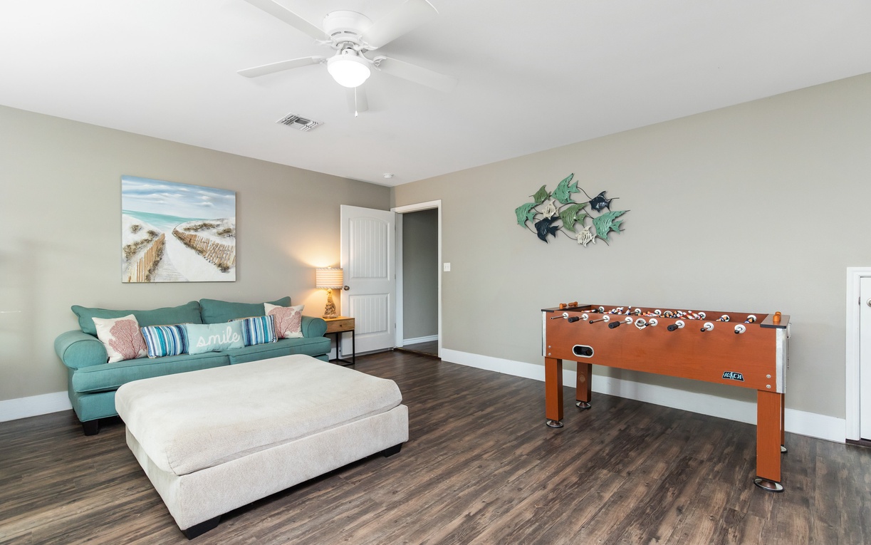 Unwind in your spacious game room with plush seating and foosball table—perfect for family fun after beach days.