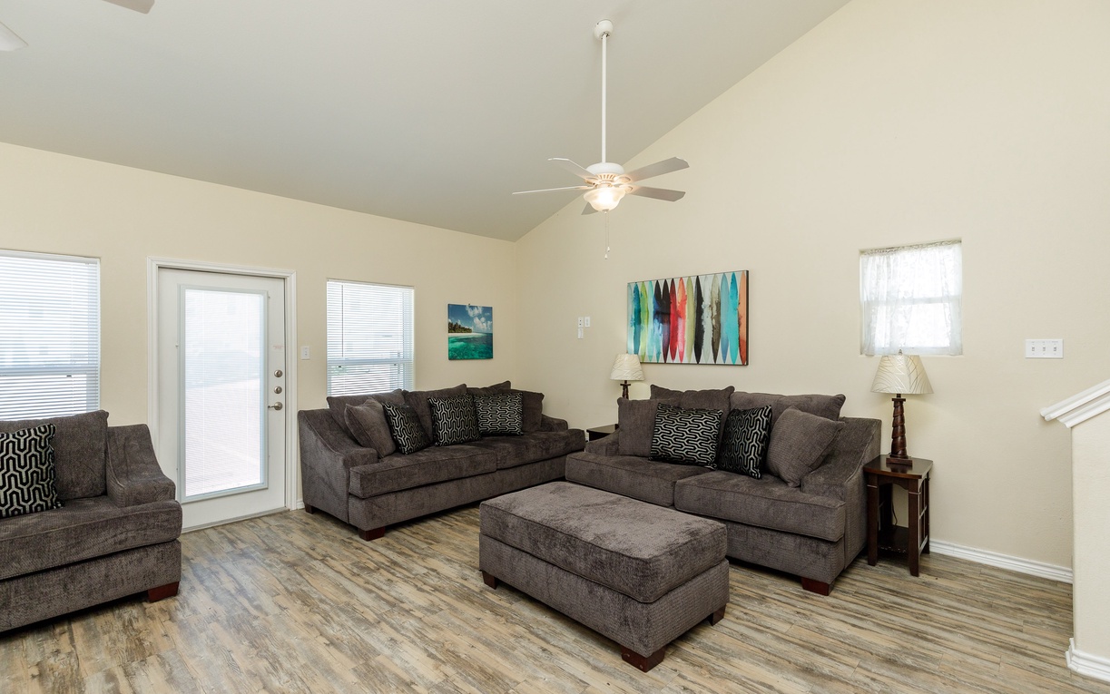 Sink into plush sectional seating where you can unwind after your adventures, with bright windows and colorful artwork creating a cheerful atmosphere.