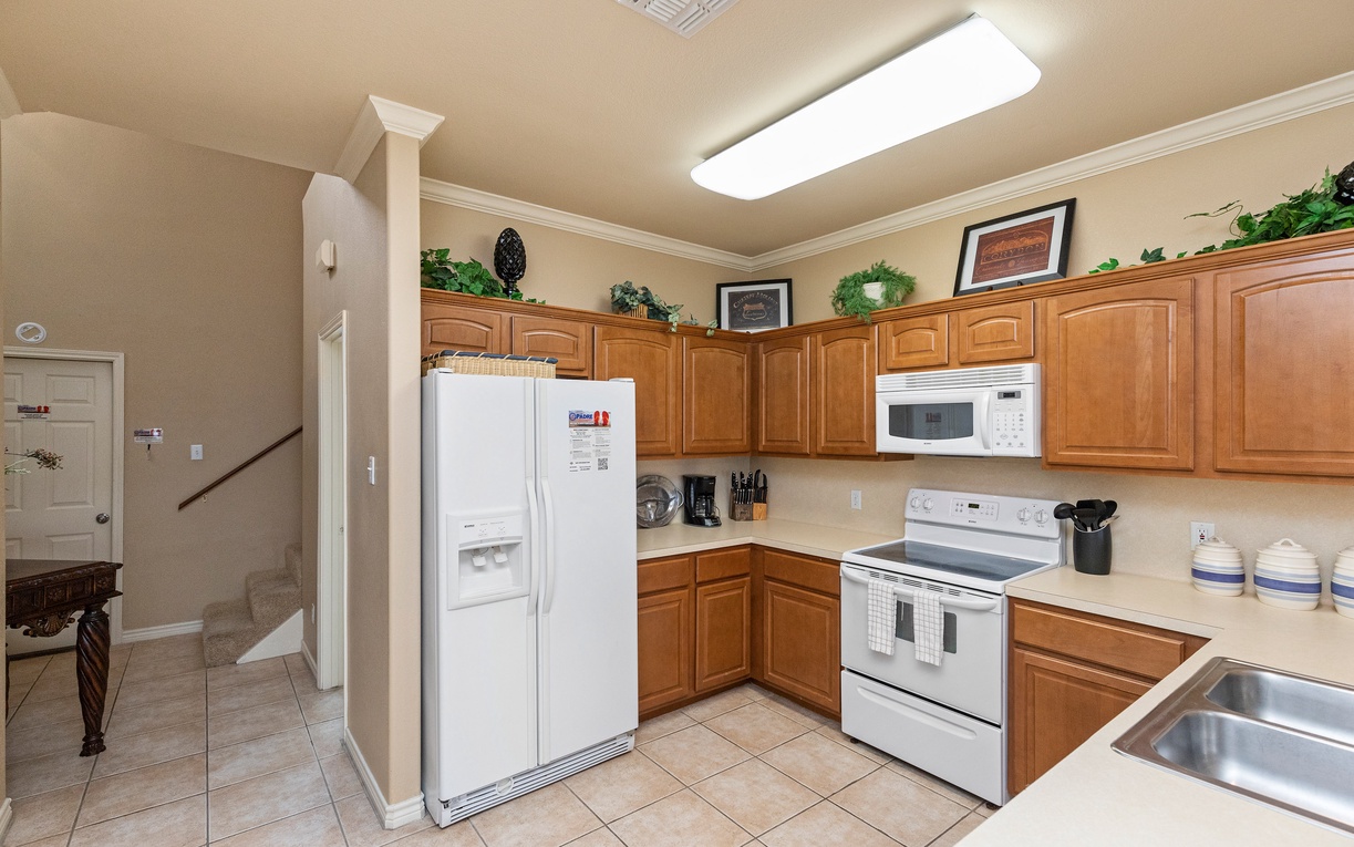 Your fully equipped kitchen awaits with warm wood cabinets, modern appliances, and everything you need to create delicious meals during your stay.