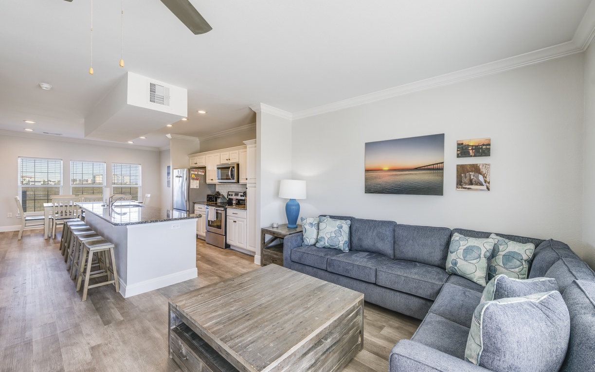 Sink into your spacious sectional sofa and take in the open-concept design where kitchen conversations flow seamlessly into living room relaxation.