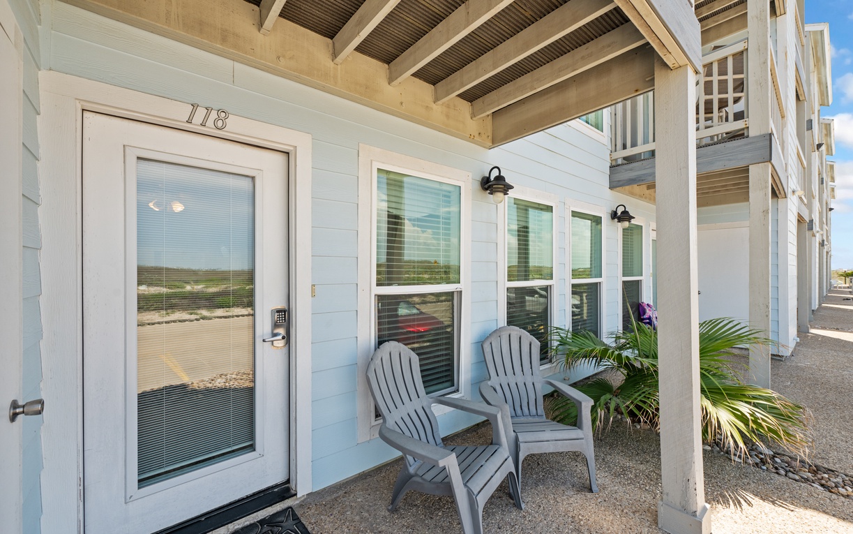 Your private entrance welcomes you to coastal comfort with Adirondack chairs perfect for morning coffee and evening relaxation on your covered porch.
