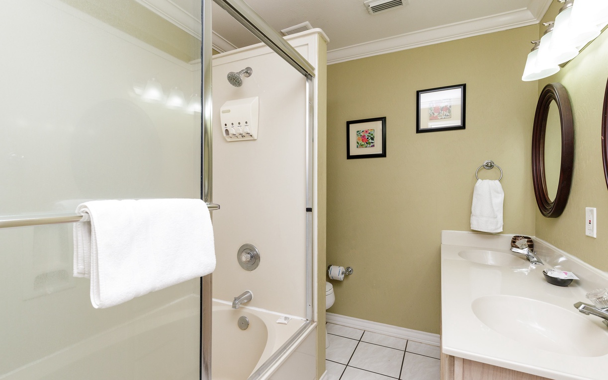 Step into your pristine bathroom featuring a spacious glass shower, elegant vanity, and thoughtful touches that make you feel right at home.