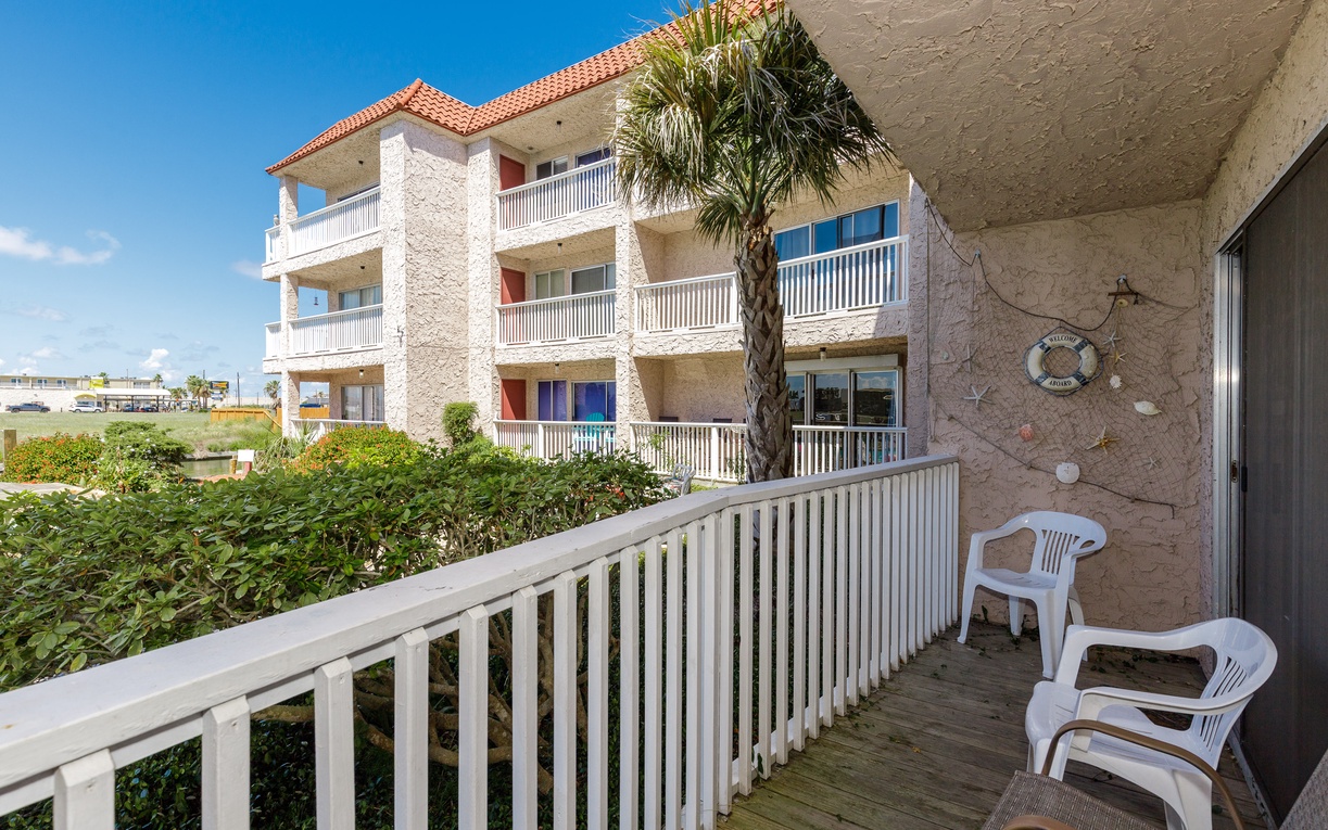 Step onto your private balcony with comfortable seating and enjoy peaceful garden views with tropical palms swaying nearby.