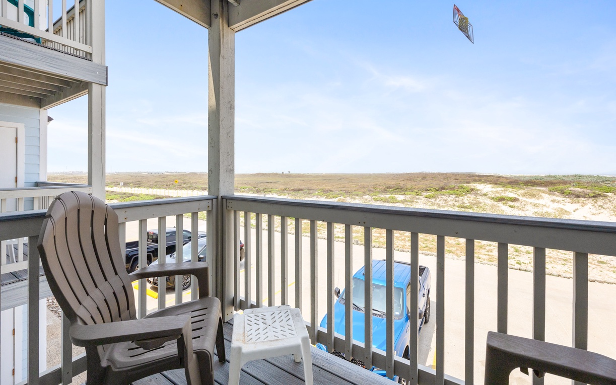 Settle into your private balcony with sweeping views of natural dunes and open sky stretching endlessly beyond.